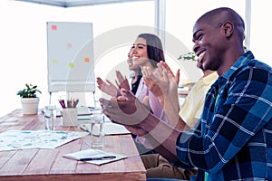 Cheerful businessman applauding in conference room