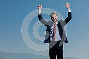 Cheerful businessman celebrating with his fist in the air