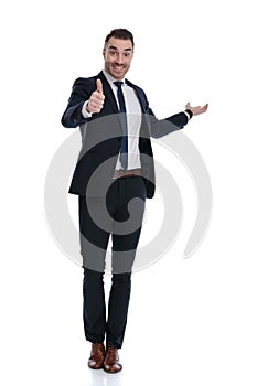 Cheerful businessman gesturing ok and inviting, laughing