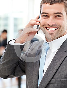 Cheerful businessman on the phone during a meeting