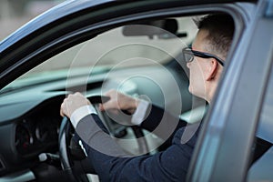 Cheerful businessman showing keys to his new car