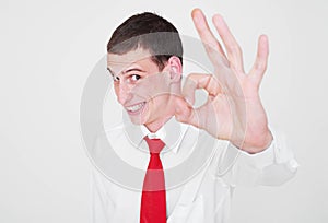 Cheerful businessman showing ok sign