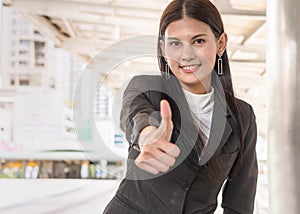 Cheerful businessman showing thumbs up