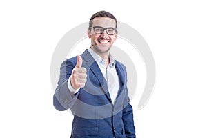 Cheerful businessman smiling broadly stretching hand shows thumb up gesture isolated on white background. Contented business