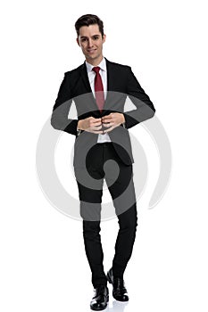 Cheerful businessman unbuttoning his jacket