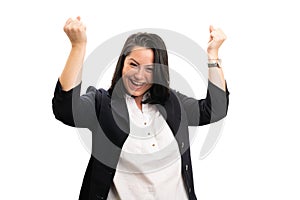 Cheerful businesswoman celebrating victory with fists gesture