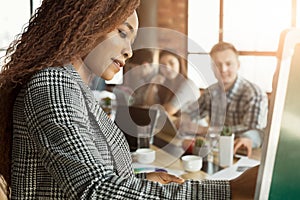 Cheerful businesswoman giving presentation to group