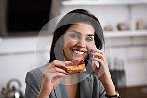 Cheerful businesswoman holding toast bread with