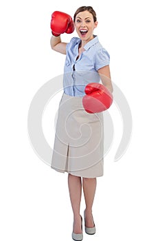 Cheerful businesswoman with red boxing gloves