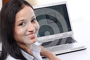 Cheerful businesswoman using laptop computer
