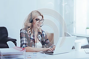 Cheerful call center operator working