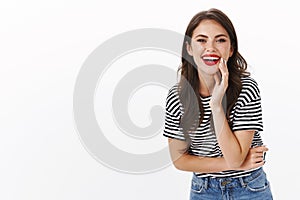 Cheerful carefree happy young girlfriend looking cheerful and delighted, laughing showing white perfect smile, wear red