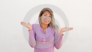 Cheerful Caucasian woman shrugging