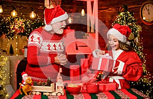 Cheerful celebration. Santa bring gifts little girl. Child enjoy christmas with bearded grandfather Santa claus. Festive