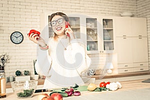 Cheerful chatty lady in white oversize sweater pleasantly talking