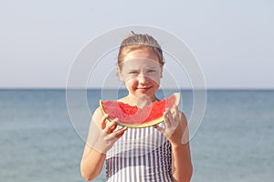 Cheerful child eating juicy watermelon. Summer food. Healthy eating seasonal berries and fruits
