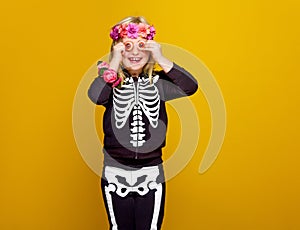 Cheerful child isolated on yellow background having fun time