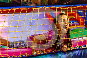 A cheerful child plays in an inflatable castle