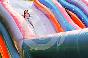 A cheerful child plays in an inflatable castle