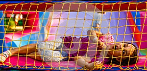 A cheerful child plays in an inflatable castle