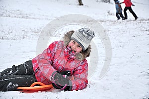 Cheerful child sledding