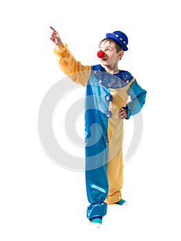Cheerful child standing in a clown suit with a blue hat and shows his hand up