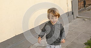 Cheerful child walking on street