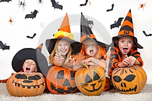Cheerful children in halloween costumes celebrating halloween