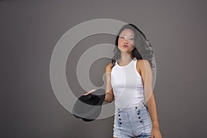 Cheerful Chinese model with her trendy hat