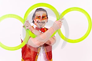 Cheerful circus performer skillfully juggling a number of rings isolated on white background