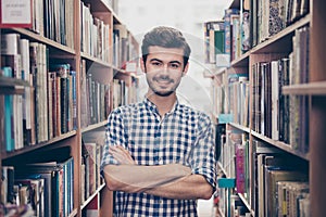 Cheerful clever young attractive brunet bearded student bookworm