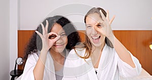 Cheerful close friends women expressing positive emotions to camera