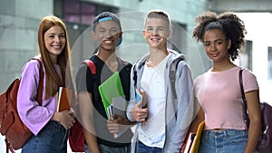 Cheerful college students looking camera outdoor, exchange educational program