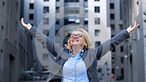 Cheerful company director raised hands up, life work satisfaction, free breath