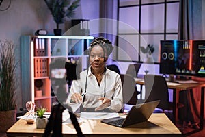 Cheerful confident african american businesswoman, broker in white shirt