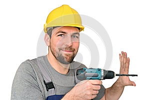 Cheerful construction worker - craftsman in working clothes with a drilling machine on white background - insulated