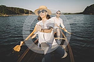 Cheerful couple enjoy canoe ride on the lake