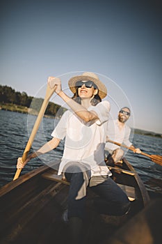 Cheerful couple enjoy canoe ride on the lake