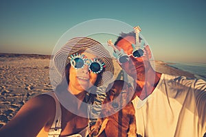 Cheerful couple, in funny sunglasses, with a small dog