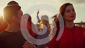 Cheerful couple hanging out at party. Young people partying in urban background