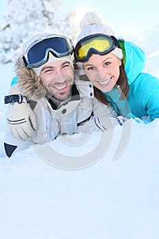 Cheerful couple having fun on ski slopes