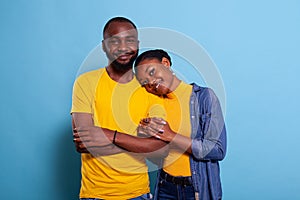 Cheerful couple holding hands and bonding in studio