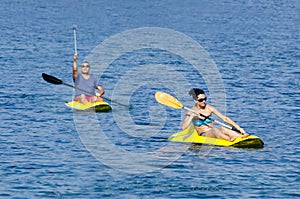 Cheerful couple paddling in kayak in the Ionian Sea