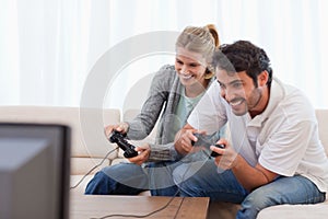 Cheerful couple playing video games