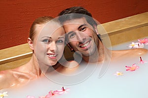 Cheerful couple relaxing in spa