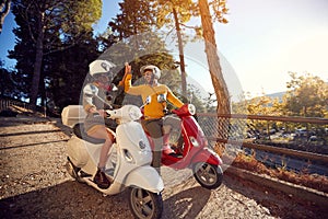 Cheerful couple riding a scooter and having fun