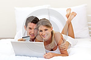 Cheerful couple shopping online