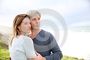 Cheerful couple standing by the seaside