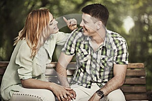 Cheerful couple talking and smiling outdoors.