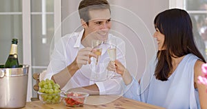 Cheerful couple toasting champagne
